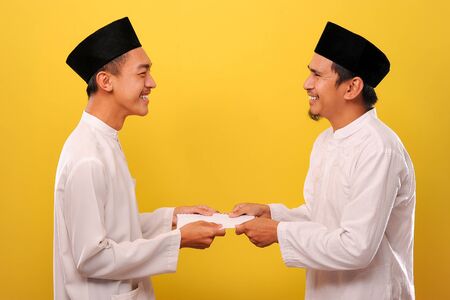 Young Asian Muslim man give alms to other muslim on Ramadan Kareem. It's the best time to give alms...