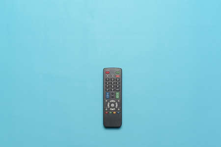 Top view of TV remote isolate on cyan background. Flatlay Photo concept