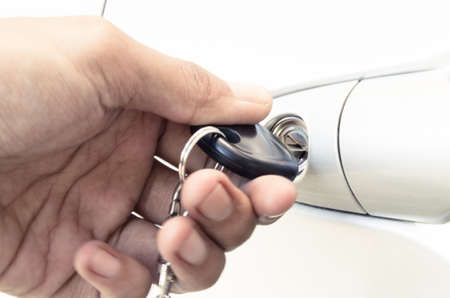 Man opens a door key of a new car の写真素材