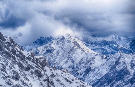 Snow and clouds in the Bavarian Alps in winterの写真素材