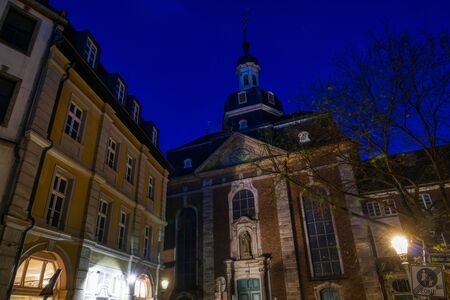 Historical church and facades at night in Duesseldorfの写真素材