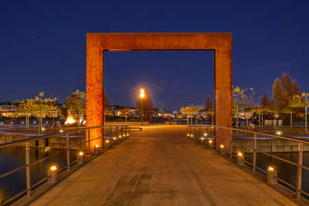 Bridge and small peninsula at lake Phoenixsee in Dortmund at nightの写真素材