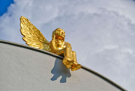 Angel sculpture on a roof in the historical center of Dusseldorfの写真素材