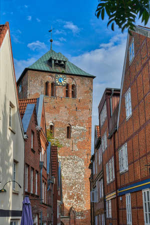 Old church tower and half-timbered buildings in the historical center of Stade