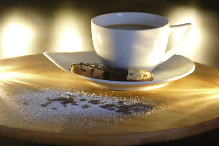 Cup of coffee with two cookies and chocolate sprinklesの写真素材