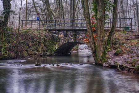 Old bridge and creek in the Neandertal valley in winter