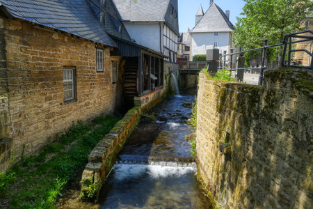Abzucht river, waterfall and romantic historical half-timbered houses in the old center of Goslarのeditorial素材