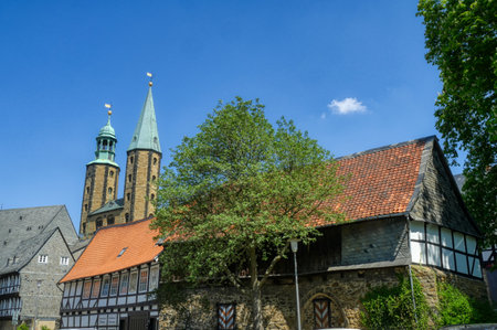 Historical half-timbered building and church tower in the old center of Goslarのeditorial素材