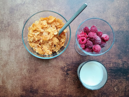 Cornflakes with raspberries and milkの写真素材
