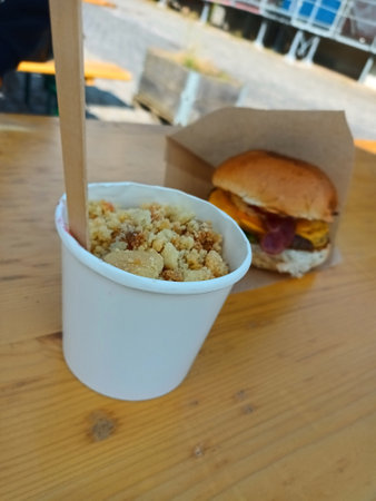 Strawberry crumble and cheeseburger with bacon wrapped in paperの写真素材