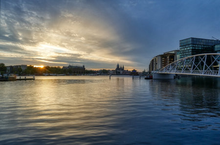 Bridge and panorama of the historical center of Amsterdam at sunsetの写真素材