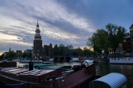 Town canal boats and historical buildings in Amsterdamの写真素材
