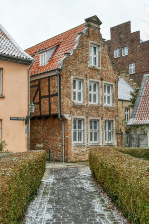 Old brick building and square in the historical center of Kaiserswerth in winterの写真素材