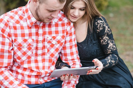 Couple walking through the city, sitting on the bench, photographed and drinking coffee