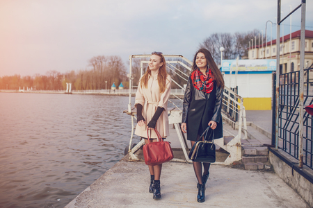 Two pretty girls walking in the cityの写真素材