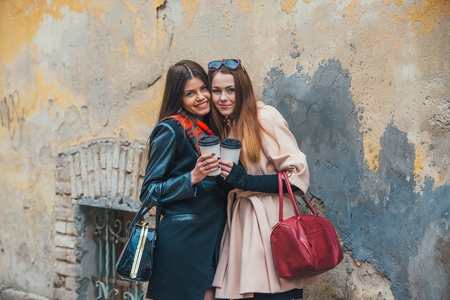 Two pretty girls walking in the cityの写真素材