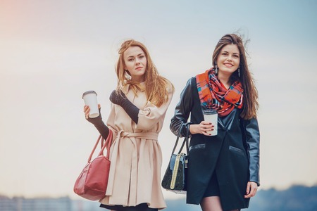 Two pretty girls walking in the cityの写真素材
