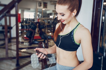The girl is engaged in the gym at the gymの写真素材