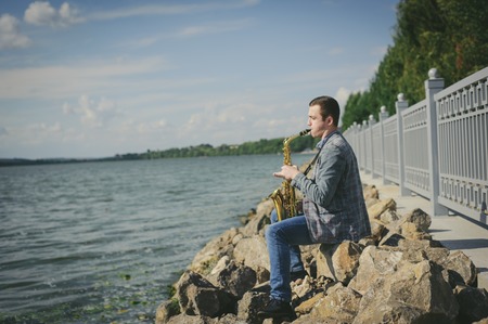 busker playing the saxophoneの写真素材