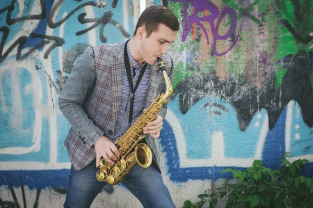 busker playing the saxophoneの写真素材