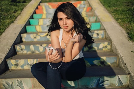 Girls walking around town, sit in cafes and pictures on phonesの写真素材