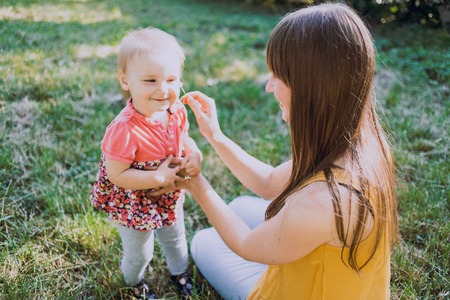 mother and daughter sitting in a cafe, walking in the park and playの写真素材