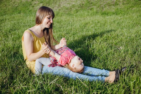 mother and daughter sitting in a cafe, walking in the park and playの写真素材