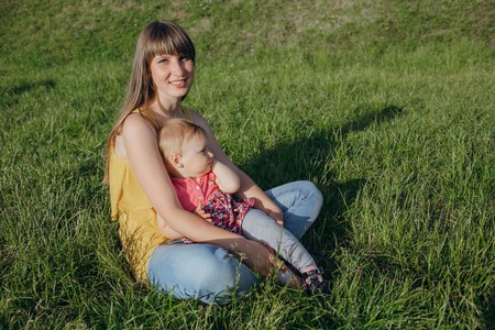 mother and daughter sitting in a cafe, walking in the park and playの写真素材