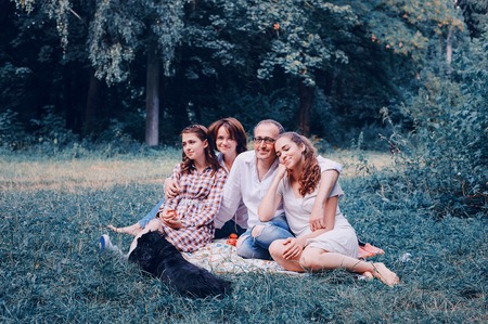 happy family on a picnic. play with the dog. good time.