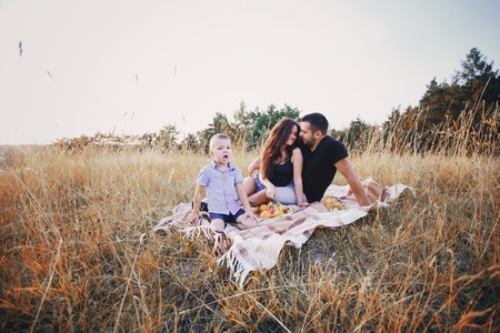 young family with a child have fun outdoors playing games love each otherの写真素材