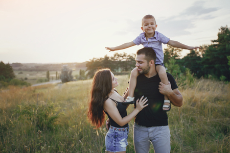 young family with a child have fun outdoors playing games love each otherの写真素材
