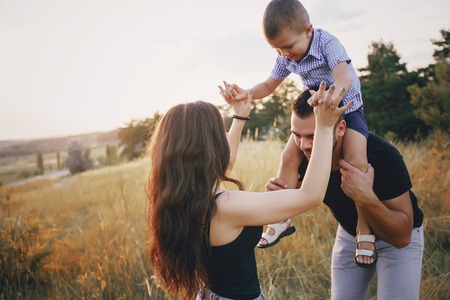 young family with a child have fun outdoors playing games love each other