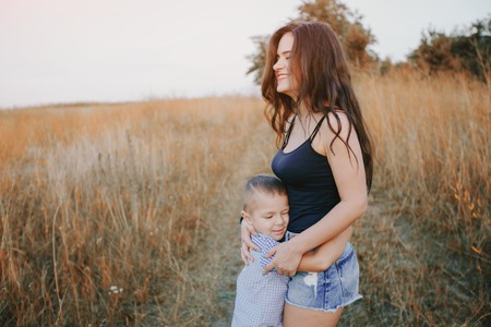 young family with a child have fun outdoors playing games love each otherの写真素材