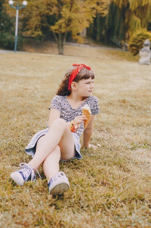 girl walking park eating ice cream good time using communicationの写真素材