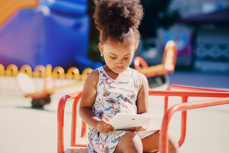 little girl walking park. uses communication. playing on the playgroundの写真素材