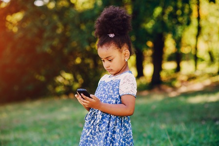 little girl walking park. uses communication. playing on the playgroundの写真素材