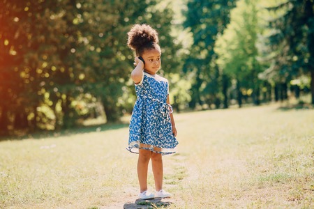 little girl walking park. uses communication. playing on the playgroundの写真素材