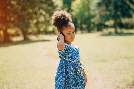 little girl walking park. uses communication. playing on the playgroundの写真素材