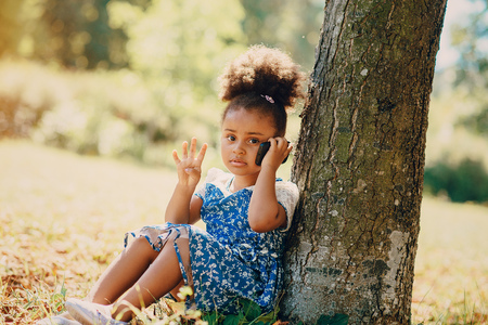little girl walking park. uses communication. playing on the playgroundの写真素材