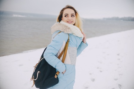 beautiful girl walking in winter park. uses communicationの写真素材