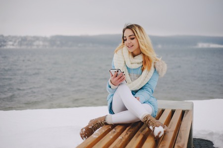 beautiful girl walking in winter park. uses communicationの写真素材