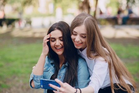 Girls walking around the city and make selfieの写真素材