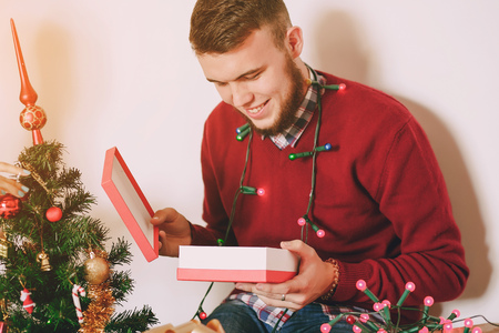 loving couple decorating Christmas tree. uses communication. give giftsの写真素材