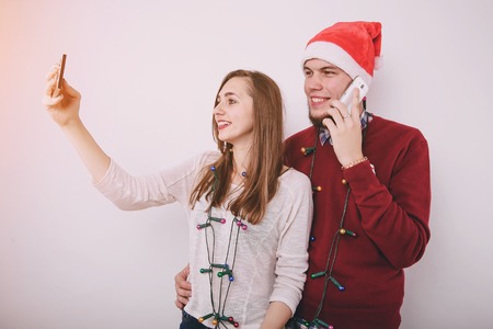 loving couple decorating Christmas tree. uses communication. give giftsの写真素材