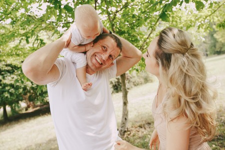 happy family a good time in the park. father, mother and little baby