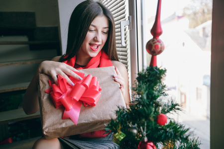 Girl decorate the Christmas tree. give gifts. pictures. good time