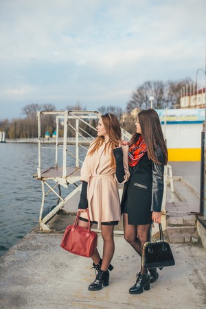 Two pretty girls walking in the cityの写真素材