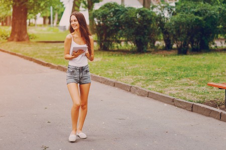 Beautiful girl is walking around the city and admire good locationの写真素材