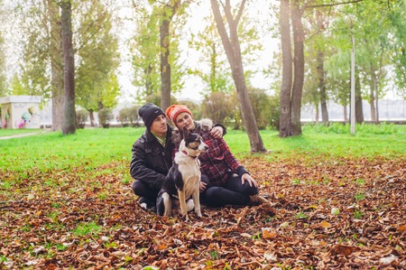 loving couple walking a dog park. good timeの写真素材