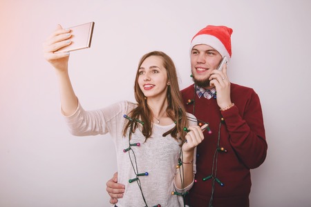 loving couple decorating Christmas tree. uses communication. give gifts